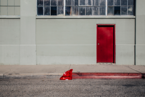 Minimal urban landscape photograph of architecture with a red door