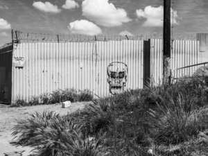 Minimal urban landscape photograph in Los Angeles with a skull on a fence